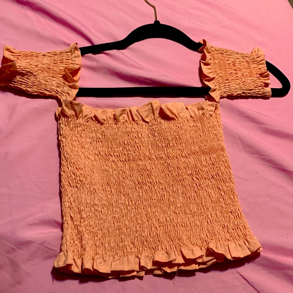 coral crop top with a ruffle bottom. It’s a size small medium